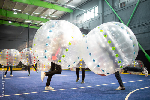 Young friends playing with bumper balls