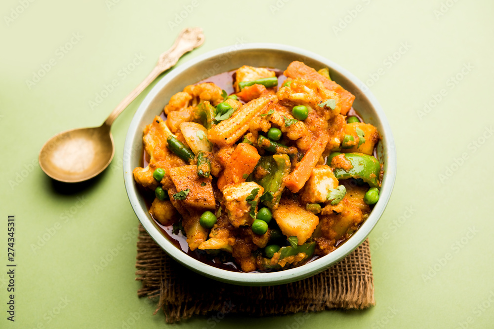 Mix vegetable curry - Indian main course recipe contains Carrots, cauliflower, green peas and beans, baby corn, capsicum and paneer/cottage cheese with traditional masala and curry, selective focus Mix vegetable curry - Indian main course recipe contains Carrots, cauliflower, green peas and beans, baby corn, capsicum and paneer/cottage cheese with traditional masala and curry, selective focus