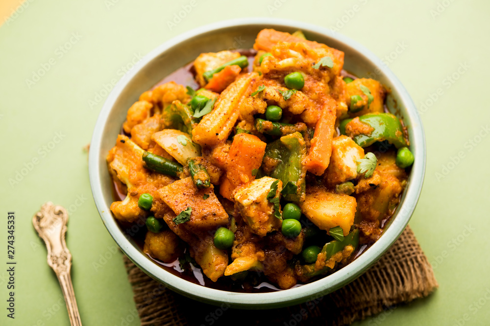 Mix vegetable curry - Indian main course recipe contains Carrots, cauliflower, green peas and beans, baby corn, capsicum and paneer/cottage cheese with traditional masala and curry, selective focus Mix vegetable curry - Indian main course recipe contains Carrots, cauliflower, green peas and beans, baby corn, capsicum and paneer/cottage cheese with traditional masala and curry, selective focus