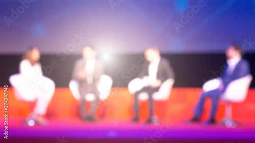 Blurred background of speakers on the stage in the conference hall or seminar meeting, business and education concept