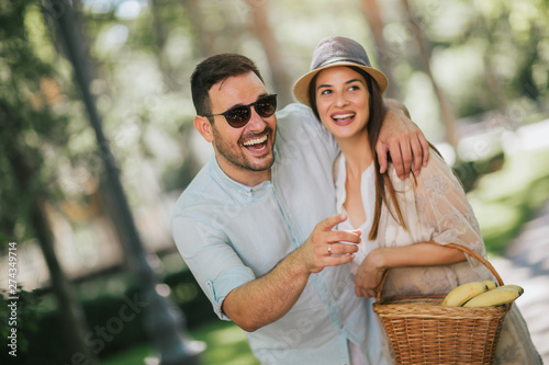 Cheerful young couple having fun and laughing together outdoors