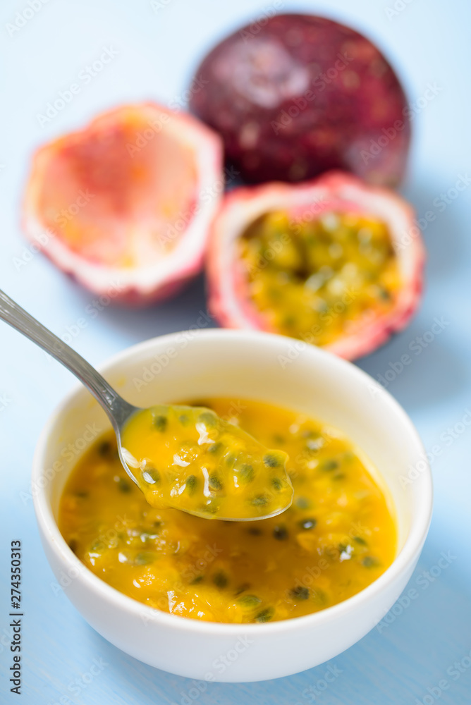 Passion fruit and juice in a bowl, top view Passion fruit and juice in a bowl, top view