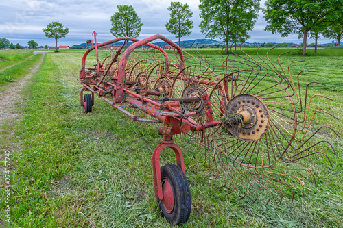 Alter Heuwender auf einer Wiese in Bayern photo