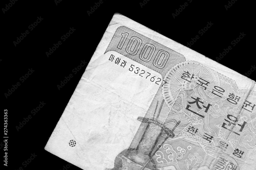Obraz premium Outdated 1000 Korean Won banknote of 1983 year close up. Black and white