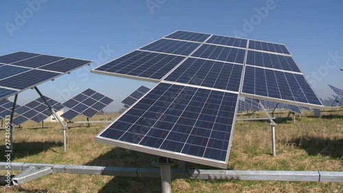 solar panels turning by sun on blue sky background