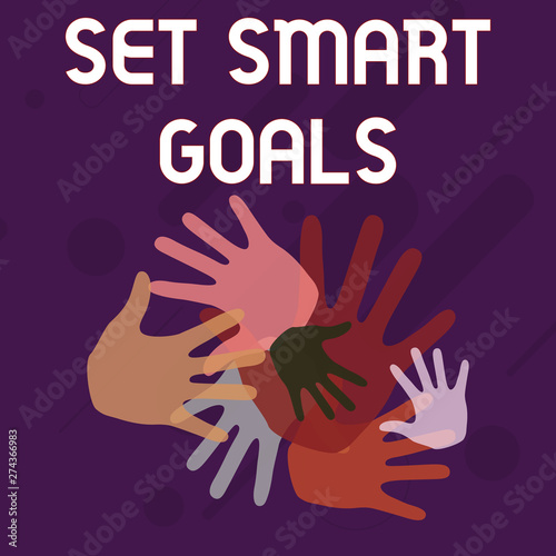 Writing note showing Set Smart Goals. Business concept for giving criteria to guide in the setting of objectives Hand Marks of Different Sizes for Teamwork and Creativity
