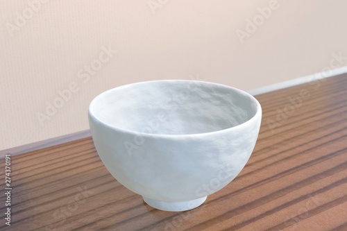 Fototapeta Naklejka Na Ścianę i Meble -  Japanese white rice bowl (empty) on a wood table (diagonal)