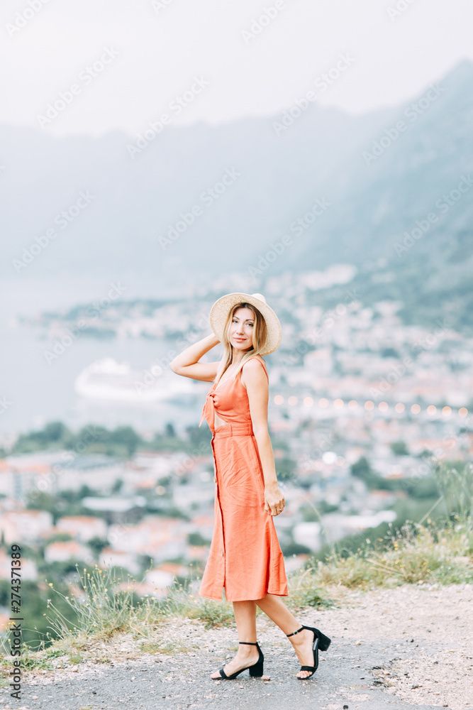 Summer photo shoot at sunset in Kotor, Montenegro. Beautiful girl in red dress and hat. Summer photo shoot at sunset in Kotor, Montenegro. Beautiful girl in red dress and hat.
