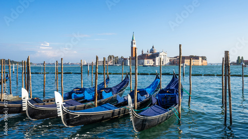 Landscape view of gondola parked beside the Riva degli Schiavoni with San Giorgio di Maggiore church in background in Venice, Italy, Europe