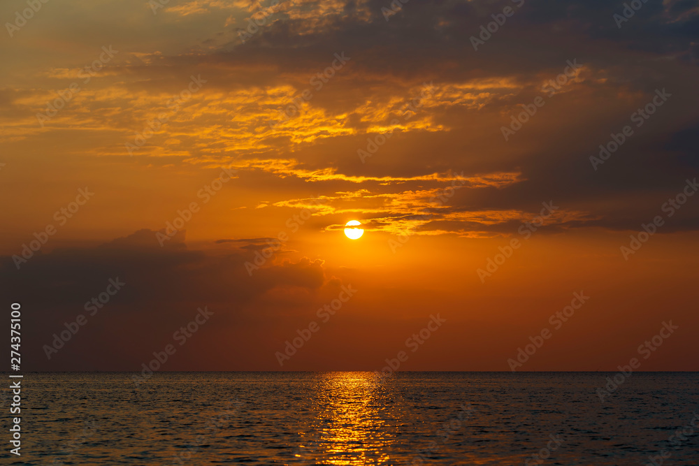Colorful sunset over calm sea water near tropical beach. Summer vacation concept. Island Phangan, Thailand