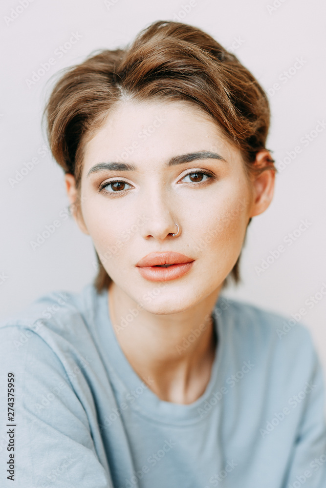 Expressive look of a woman. Portrait of a stylish young girl in the interior Studio. Expressive look of a woman. Portrait of a stylish young girl in the interior Studio.