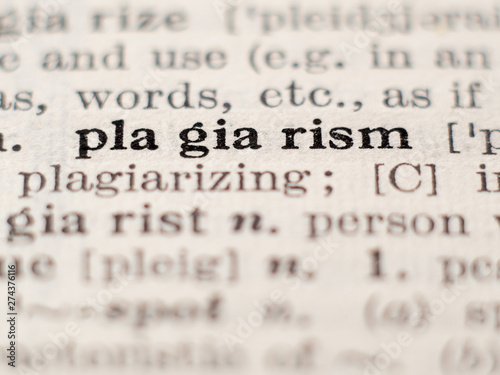 Dictionary definition of word plagiarism, selective focus. photo