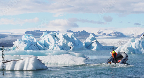Fotografi Vatnajokull National Park, Iceland - September 5 2018, a man sailing motor boat