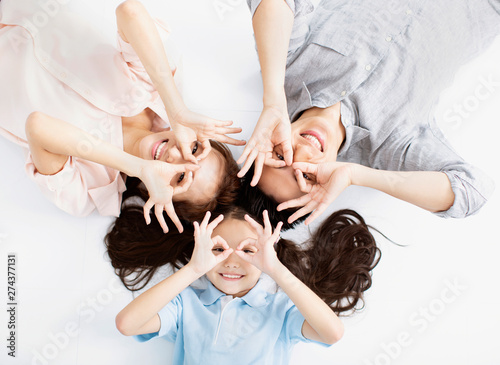 Top view of Happy asian Family lying on the floor photo