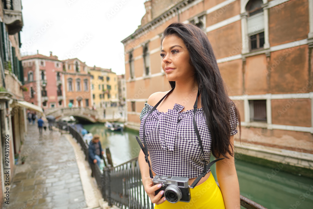 Smiling woman Tourist Takes Photos In Italy