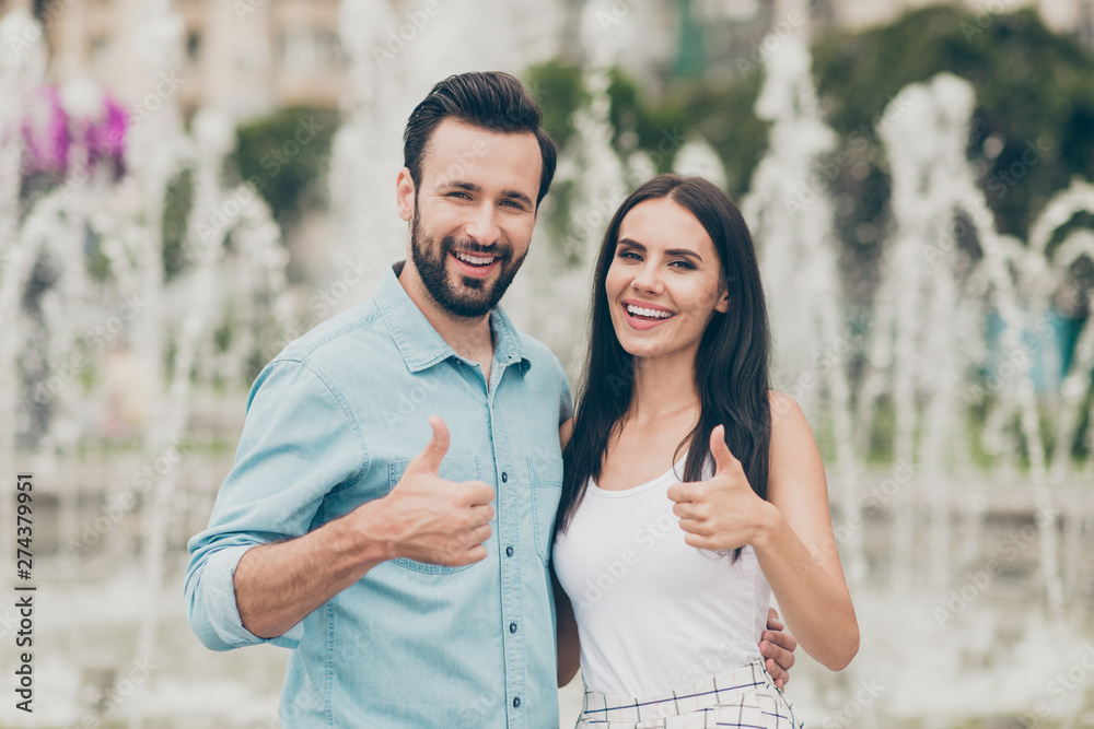 Portrait of cute lovely people married spouse have free time holiday weekend stroll fountain nature park town center trendy stylish handsome singlet shirt blue denim jeans outside bearded