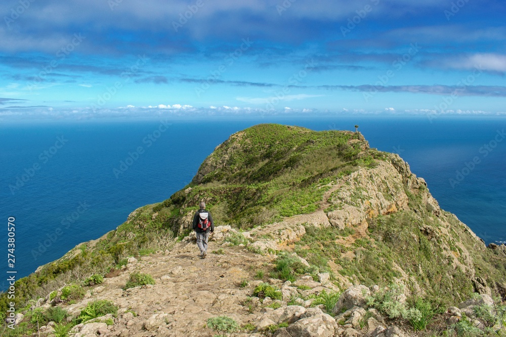 Man hiker walking in beautiful costal scenery. - Tenerife, Canary Islands,  Spain. Western coast view, mountain Anaga