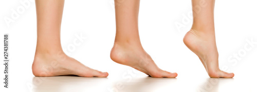 Side view of female bare foot in three different positions on white background © Jasmina