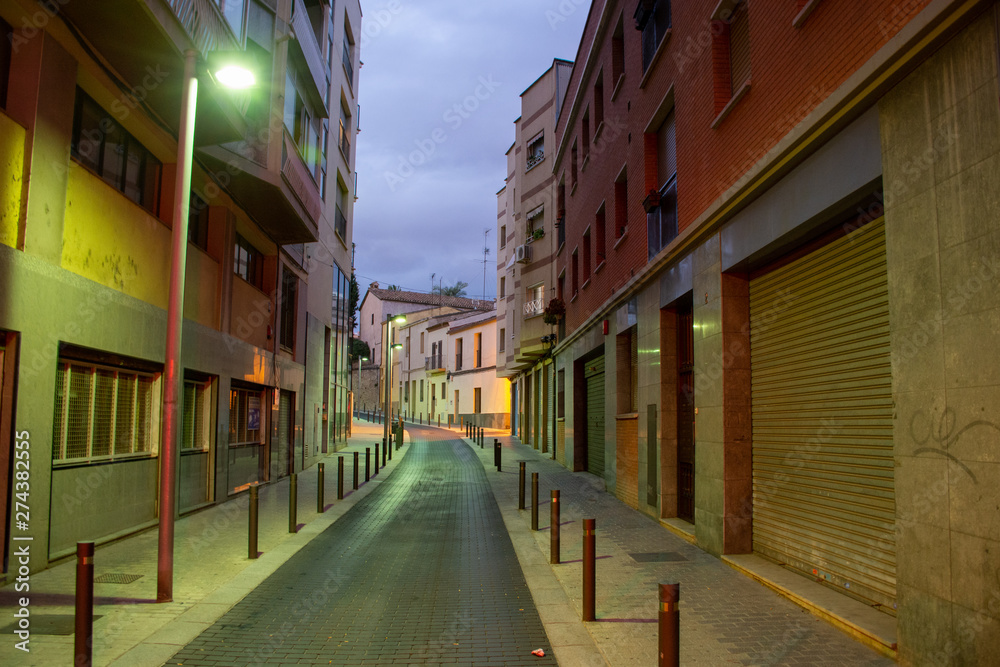 Fototapeta premium Barcelona, Spain - 25th July 2017 - Long street with posts leading into the uknown
