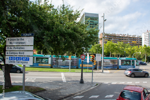 Barcelona, Spain - 26th July 2017 - Campus Nord sign post with moving tram behind