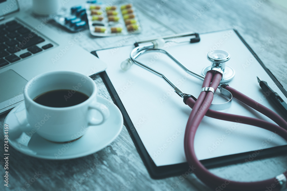 DOCTOR WORKPLACE WITH A STETHOSCOPE ON TABLE CONCEPT DOCTOR WORKPLACE WITH A STETHOSCOPE ON TABLE CONCEPT