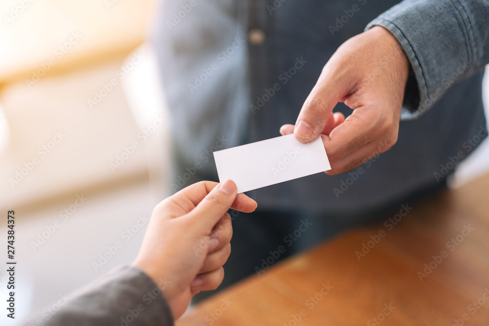 Two businessman holding and exchanging empty business card Two businessman holding and exchanging empty business card