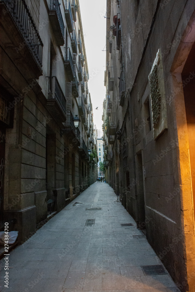 Barcelona, Spain - 26th July 2017 - People or tourists walking through a long alley to the shops