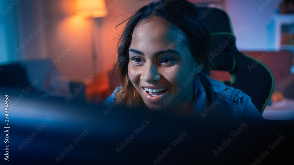 Beautiful Surprised and Excited Young Black Girl Blogger Watching Action  Video on a Computer. She Has