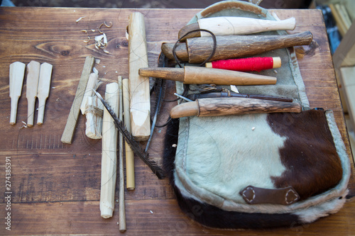 Tools for making wooden instruments zhaleyka, flutes. Selective focus. Folk wooden musical instruments Leisure Hobbies.