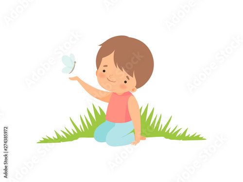 Cute Happy Boy Sitting on Green Meadow and Playing with Butterfly, Adorable Little Kid Cartoon Character Playing Outside Vector Illustration