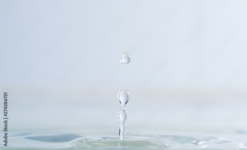 Splash from a drop of water on a light background macro Splash from a drop of water on a light background macro