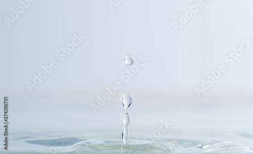 Splash from a drop of water on a light background macro
