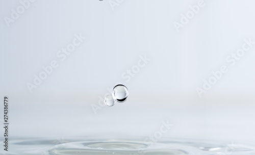 Splash from a drop of water on a light background macro