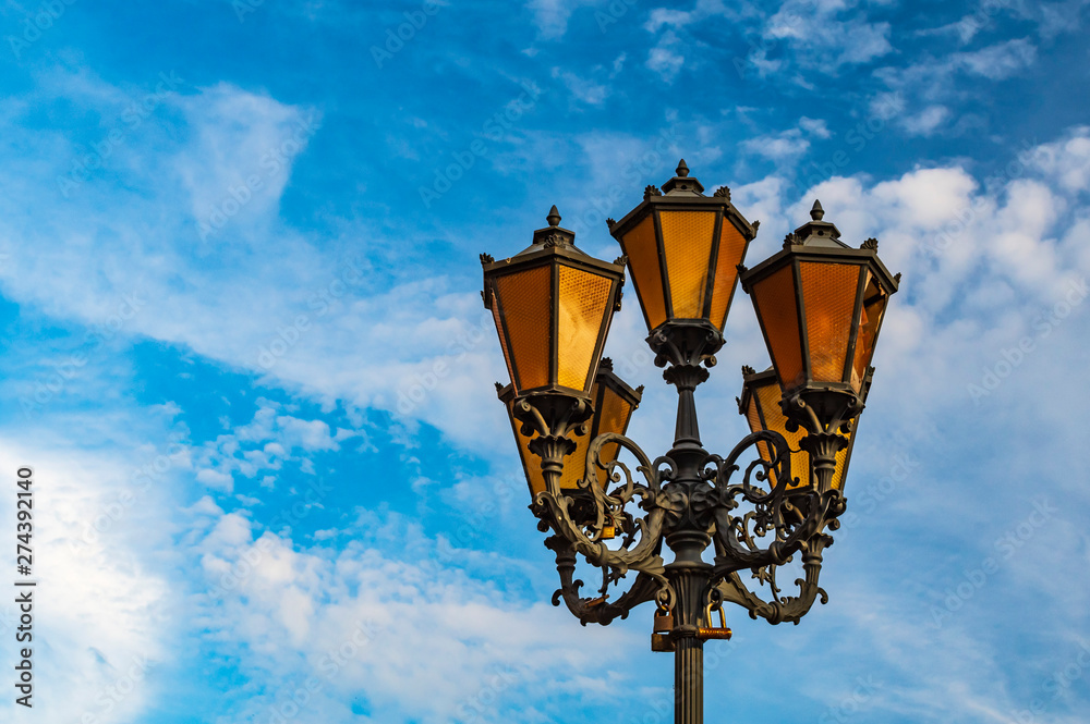 Vintage street lamp against blue sky