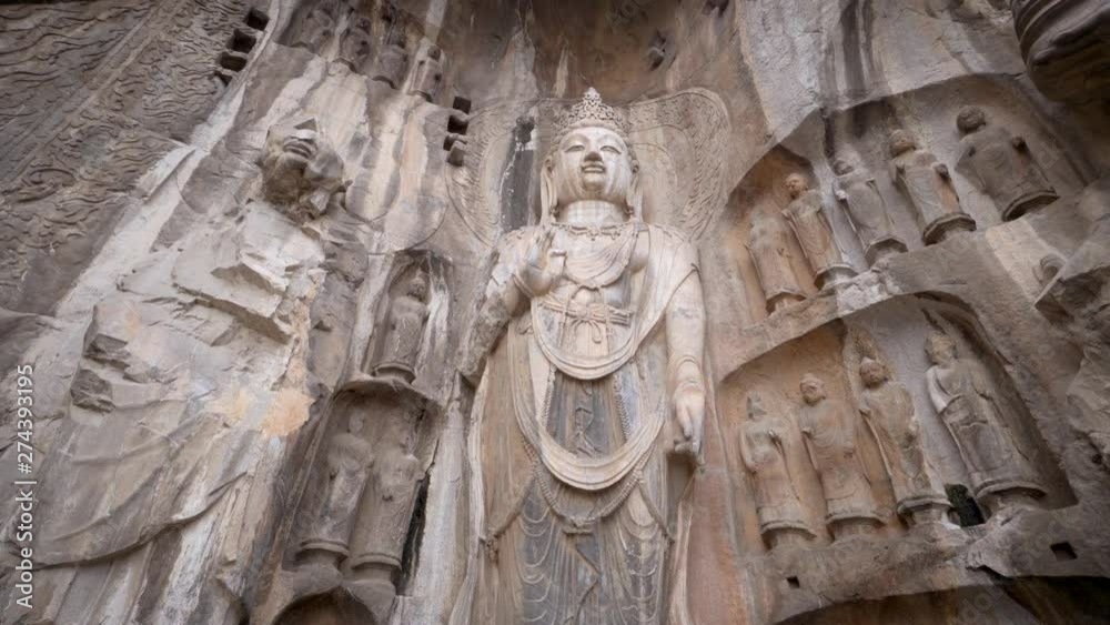 Giant Bodhisattva statue in the famous Longmen Grotto in Luoyang, Henan Province, China. finest art of stone carving. Statue was dated from China's Tang Dynasty. Giant Bodhisattva statue in the famous Longmen Grotto in Luoyang, Henan Province, China. finest art of stone carving. Statue was dated from China's Tang Dynasty.