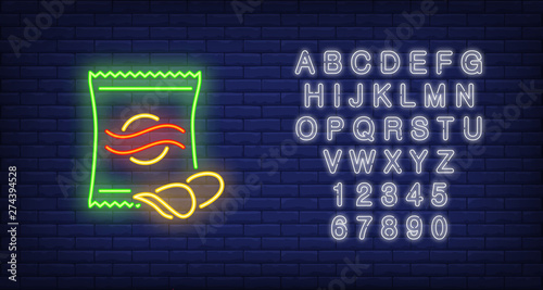 Chips packet neon sign. Glowing illustration of green packet with potato chips on dark blue brick background. Can be used for store, shops, supermarkets, advertisement