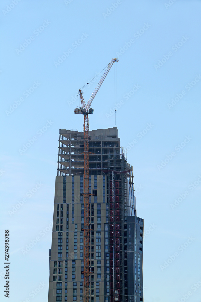 A Very High Jib Crane on a Tall Building Construction.