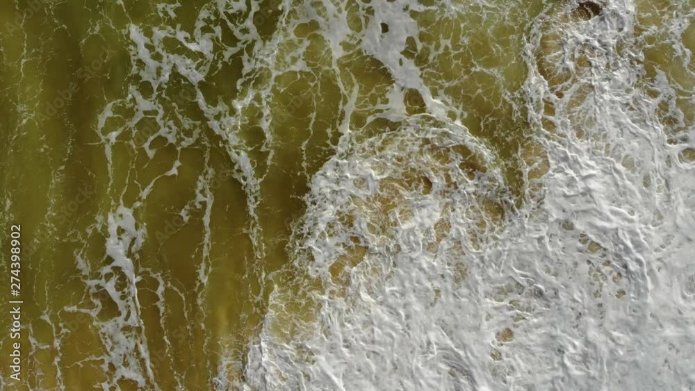 Foam of Waves Crashing on the Beach