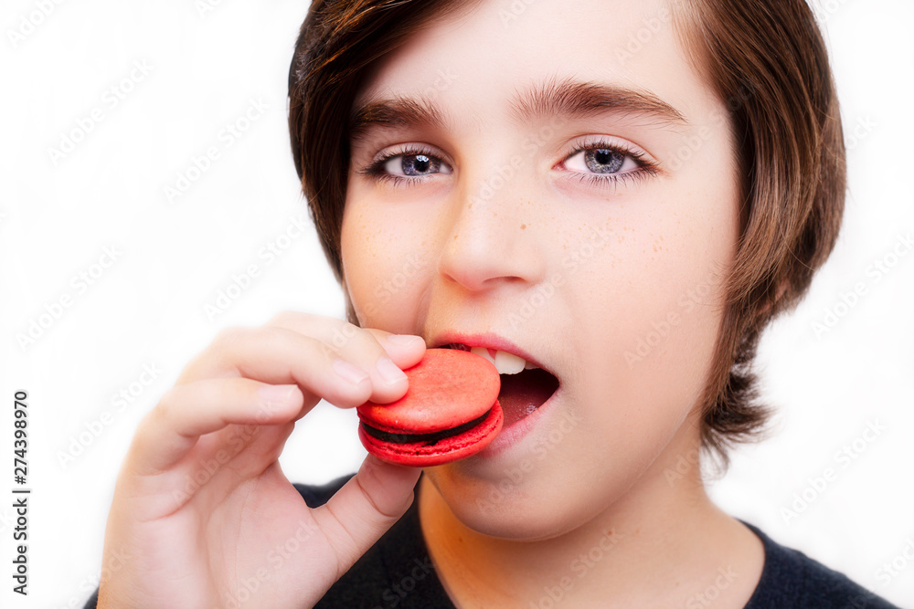 Handsome boy eating macaroni over white background. Handsome boy eating macaroni over white background.