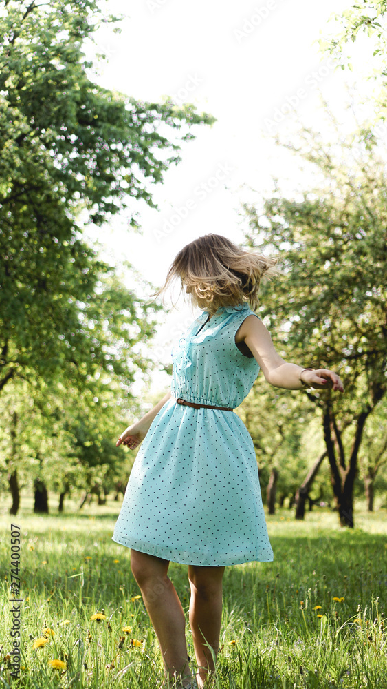 Young woman in sunny garden. Outdoor summer day. Meditation and freedom concept Young woman in sunny garden. Outdoor summer day. Meditation and freedom concept