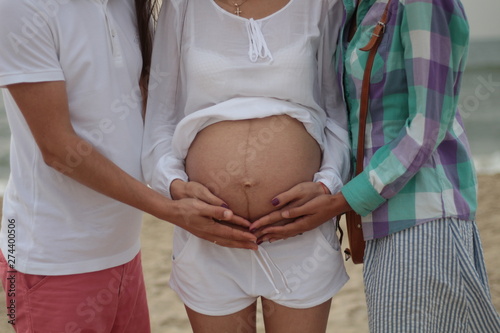surrogate motherhood concept. pregnant woman and married couple