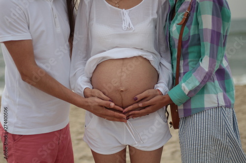 surrogate motherhood concept. pregnant woman and married couple photo