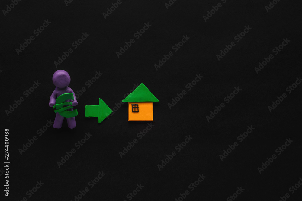 A man holding money next to an arrow pointing towards a house, shot from above, A man holding money next to an arrow pointing towards a house, shot from above,