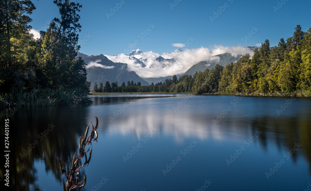 Mount Cook is reflecting in the water of Lake Matheson in New Zealand