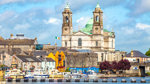 Beautiful view of the parish church of Ss. Peter and Paul and the castle in the town of Athlone next to the river Shannon, wonderful cloudy day in the county of Westmeath, Ireland photo