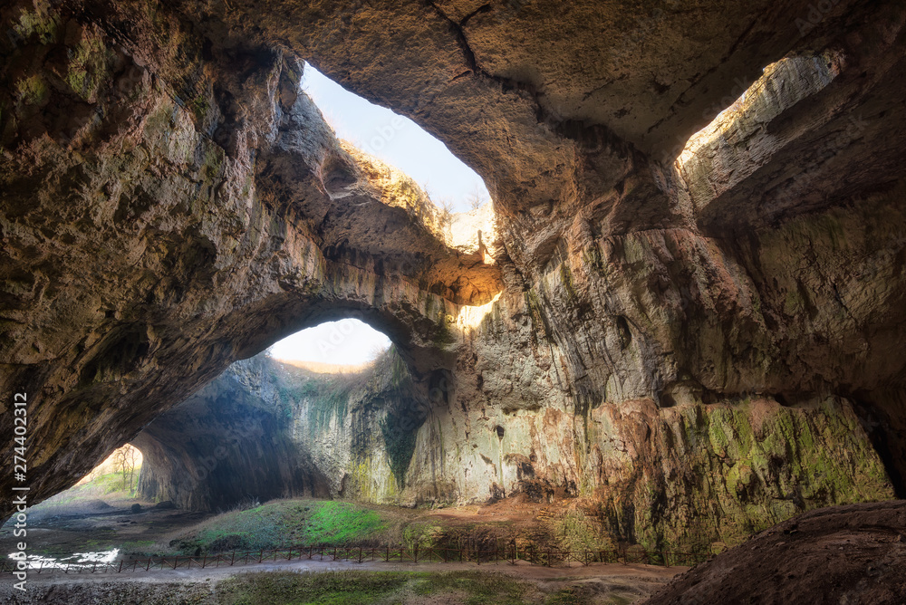 The magic cave / Magnificent view of the Devetaki cave, one of the largest and most picturesque caves in Bulgaria - obrazy, fototapety, plakaty 