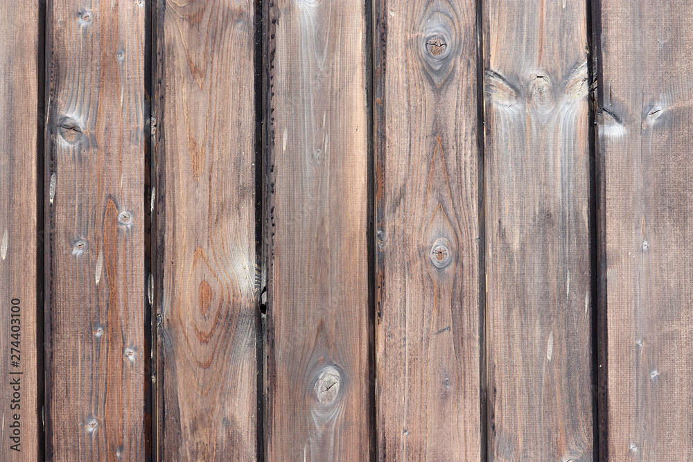 Fototapeta premium Wooden flooring, old wood boards. Dark knotted panels texture for the background