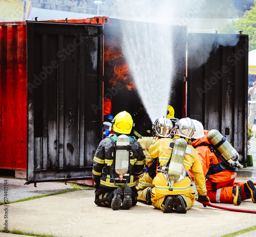 The Back side view of a group of teamwork  .firefighters helped stop the fire. © kowitstockphoto