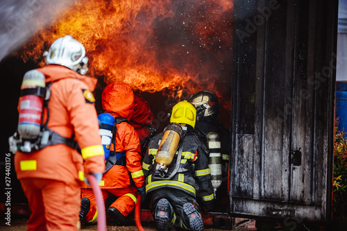 The Back side view of a group of teamwork .firefighters helped stop the fire.