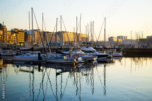 View of the dock of Gijon, Asturias, Spain, with reflections in the water, in Cimadevilla, the old town, during the sunset. Peaceful place